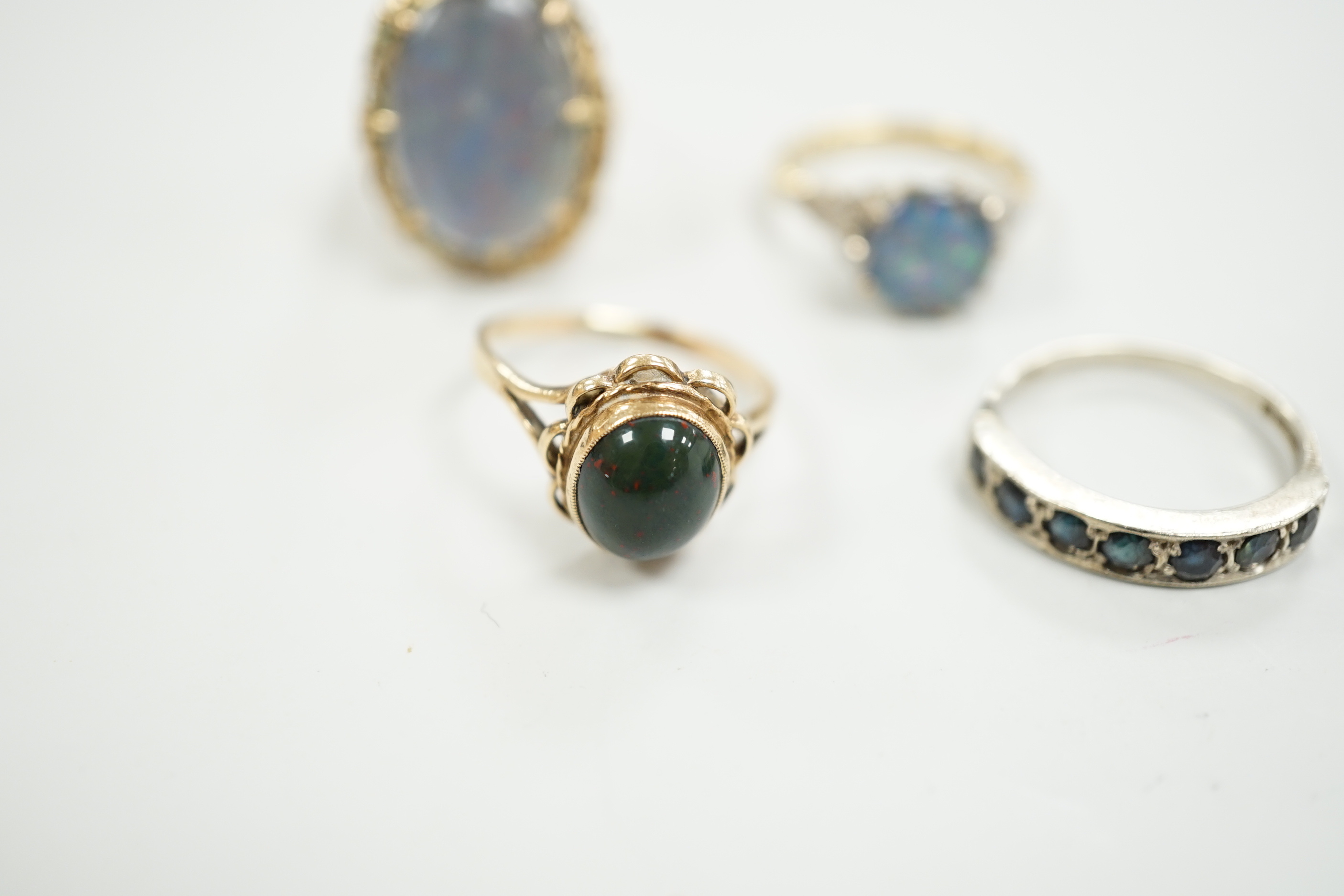 A 1940's 18ct and black opal doublet set dress ring, with diamond chip set shoulders, size L, a 14c and oval doublet ring and two other 9ct and gem set rings.